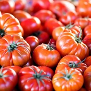 red tomato on brown wooden table